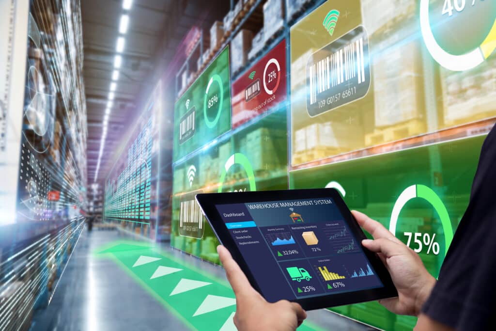 Smart Augmented Reality,AR warehouse management system.Worker hands holding tablet on blurred warehouse as background